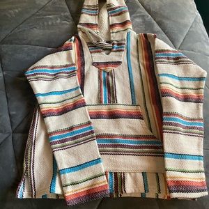 A white poncho with colorful stripes
